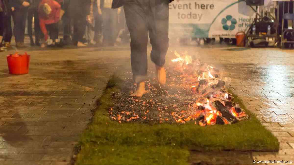 Brave fundraisers walk barefoot on hot coals in charity fire walk