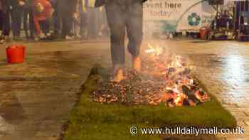 Brave fundraisers walk barefoot on hot coals in charity fire walk