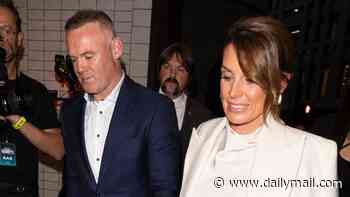 Coleen Rooney looks glamorous in a head-to-toe white satin look as she joins dapper husband Wayne at the premiere of their Disney+ series amid claims he's 'set to follow her into the I'm A Celeb jungle'