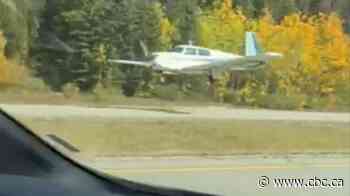 Plane lands on Highway 1 in Banff National Park