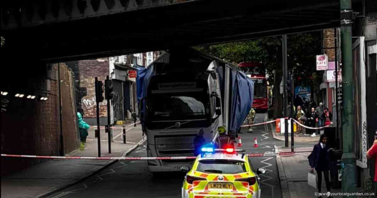 LIVE updates as lorry strikes bridge causing south London high street to close