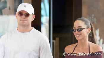 Smiles on the sidelines! Footy star Lachie Neale looks unfazed by Grand Final heartbreak as he steps out with girlfriend Emma Field in Brisbane following tribunal disaster