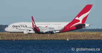Man charged after allegedly trying to open Qantas plane door mid-flight