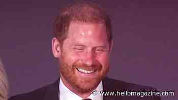 Prince Harry is barely recognisable as he frolics on the floor in very un-royal moment