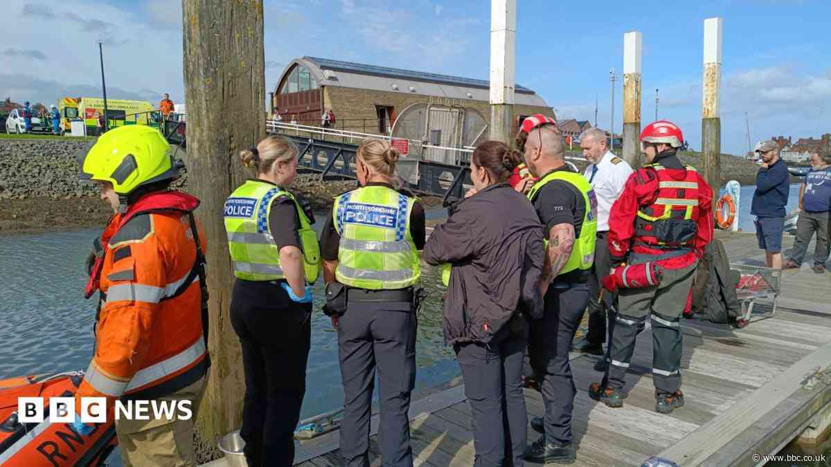 Man working on boat carries out harbour car rescue
