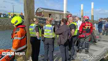 Man working on boat carries out harbour car rescue