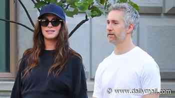 Pregnant Anne Hathaway, 43, looks ready to pop on rare outing with her husband Adam Shulman and two kids
