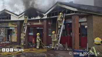 Homes evacuated after fire spreads through shops