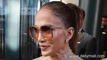 Jennifer Lopez looks casually chic in a sheer lace top and stylish jeans as she leaves her hotel in Milan amid Fashion Week