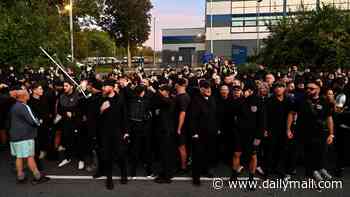 'Danny Tommo' is charged with criminal damage - as hundreds of black-clad supporters gather outside police station in protest at his arrest