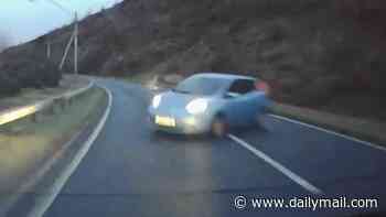 Terrifying moment out-of-control car smashes into driver in head-on crash after hurtling around bend