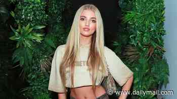 Princess Andre, 19, shows off her toned abs in a cropped T-shirt and jeans and accessorises with a Gucci bag as she poses at Outside premiere