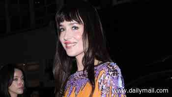 Dakota Johnson wears a bold orange and purple dress to attend Valentino Beauty event in London after the Verity premiere