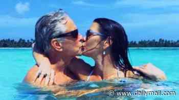 Catherine Zeta-Jones, 57, passionately kisses husband Michael Douglas, 82, while he declares he fell in love the moment he saw her on screen - as couple celebrate their joint birthday