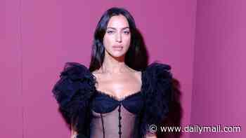 Irina Shayk wears a semi-sheer corset with leg-flashing tiered skirt as she steals the show on the Blumarine catwalk at Milan Fashion Week