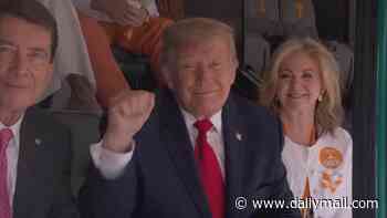Donald Trump met with roaring cheers from college football fans in Tennessee... as president jets in for SEC showdown