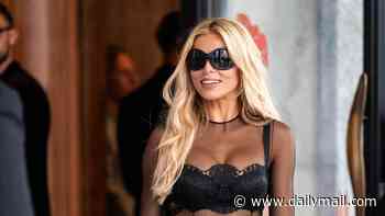 Brooks Nader flaunts her incredible figure in a sheer dress and stockings during Milan Fashion Week