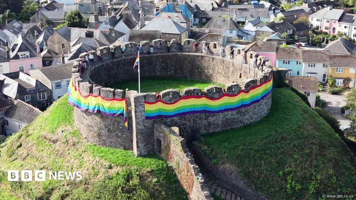Rainbow flag wrapped around castle for Pride event