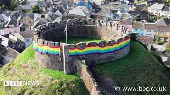 Rainbow flag wrapped around castle for Pride event