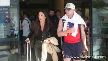 Lachie Neale has girlfriend Emma Field by his side as he returns home after AFL Grand Final win - following her VERY public support for her new man