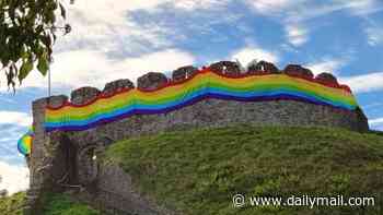 Fury as town's historic castle is draped in giant rainbow flag during Pride festival celebrations