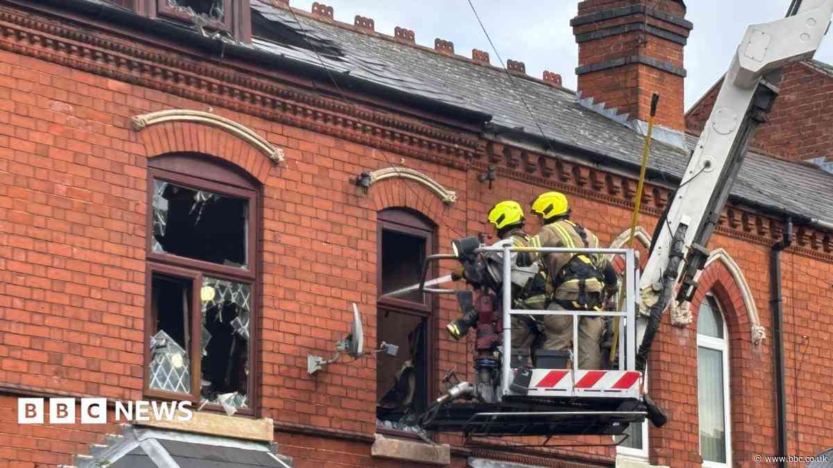 Dozens of firefighters tackle house fire
