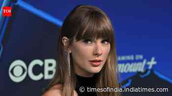 Taylor Swift attends MTV VMAs in 2026 in a black and silver floor-length dress