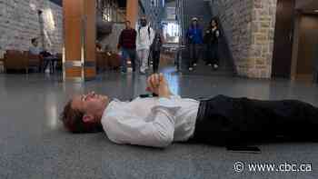 Why this Sask. university student lies down on the floor in public
