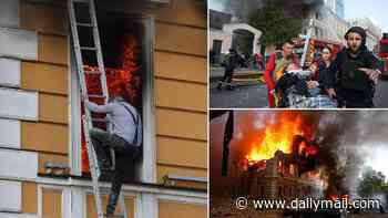 Russian drone slams into Kyiv's National Academy of Sciences building with trapped victims climbing out of windows to escape inferno