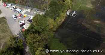 Pictures from the scene as burst water main floods Surrey recreation ground