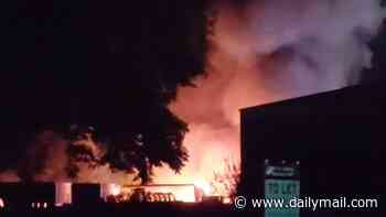 Huge fire erupts on industrial estate with 'explosions heard' and trains cancelled