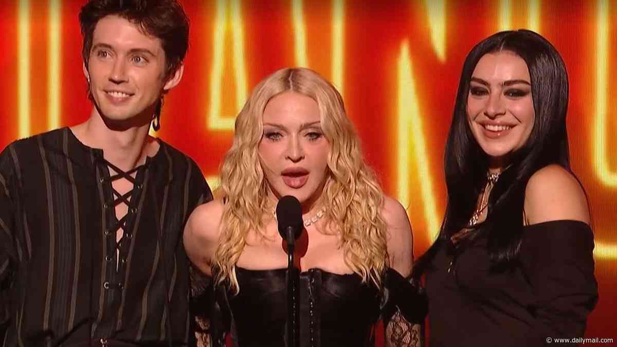 Madonna puts on bizarre display as she rolls around in bed with Charli XCX and Julia Garner after 'confused' VMAs performance