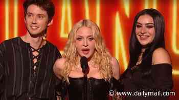 Madonna puts on bizarre display as she rolls around in bed with Charli XCX and Julia Garner after 'confused' VMAs performance