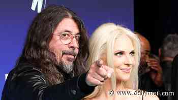 Dave Grohl slammed for making his wife Jordyn Blum look at the cameras on the red carpet at the VMAs before leaving her trailing behind him  - after cheating and love child scandal rocked their marriage