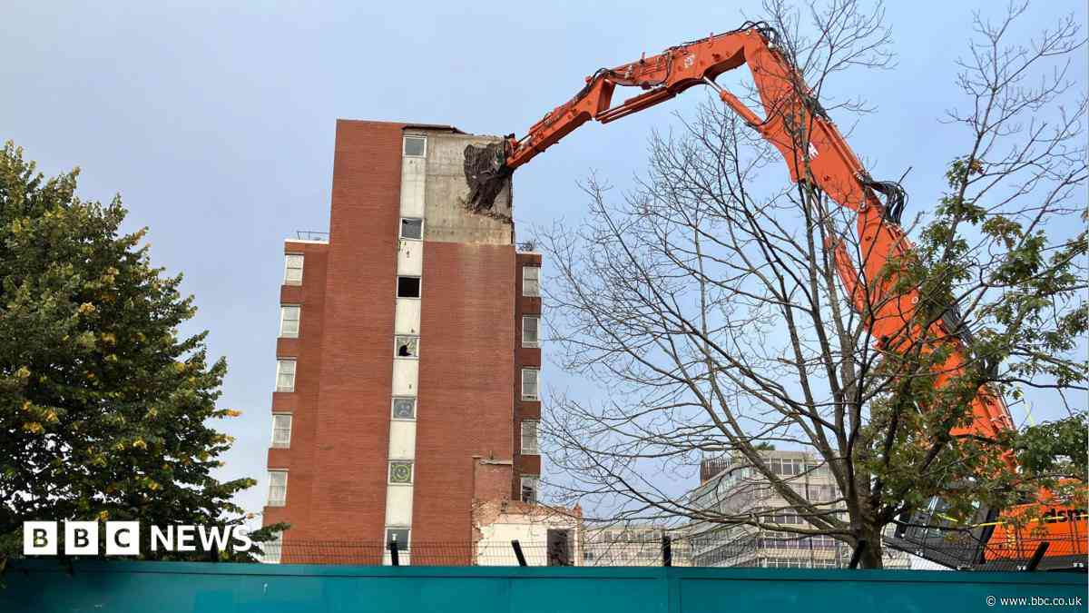 Giant machine tears down city centre office block