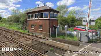 Train delays after car crashes into level crossing