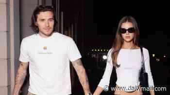 Brooklyn Beckham and Nicola Peltz walk hand in hand as they arrive in the French capital for Paris Fashion Week - just days before estranged mum Victoria's iconic show