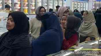 Customers at Asian supermarket in east London form separate male and female queues as they wait in line for discounted cooking oil