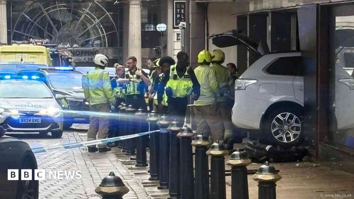 Car hits woman before ploughing into building