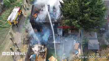 Crews tackle house fire which spreads to roofs