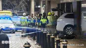 Car hits woman before ploughing into building