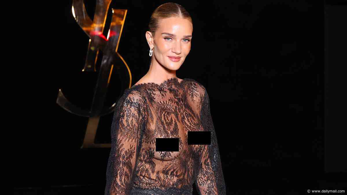 Rosie Huntington-Whiteley stuns in her most daring look to date as she pushes boundaries in a sheer lace dress at the Saint Laurent Paris Fashion Week show