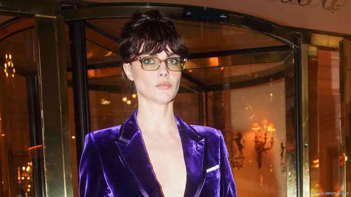 Cara Delevingne goes bold in a plunging purple velvet suit as she heads to Tom Ford's Paris Fashion Week show