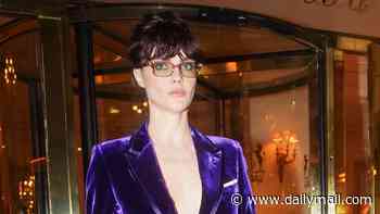 Cara Delevingne goes bold in a plunging purple velvet suit as she heads to Tom Ford's Paris Fashion Week show