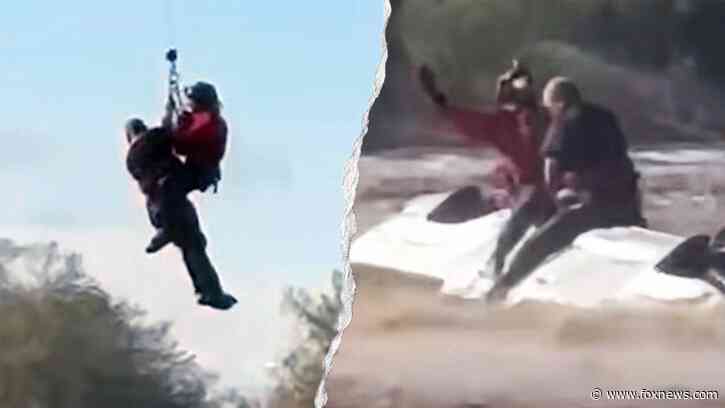 Arizona sheriff's helicopter crew rescues man stranded atop overturned truck in rapidly rising floodwaters