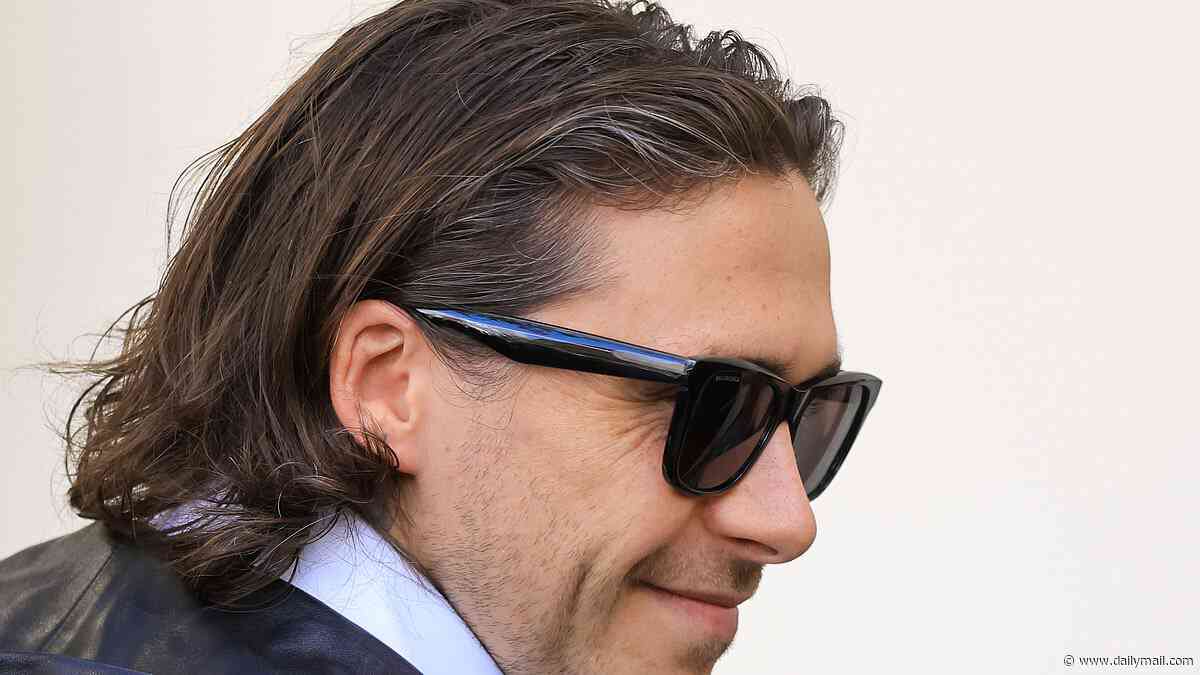 Brooklyn Beckham, 27, reveals salt and pepper flecks in his hair as he and Nicola Peltz arrive at the Balenciaga show - one day before estranged mum Victoria's Paris Fashion Week event