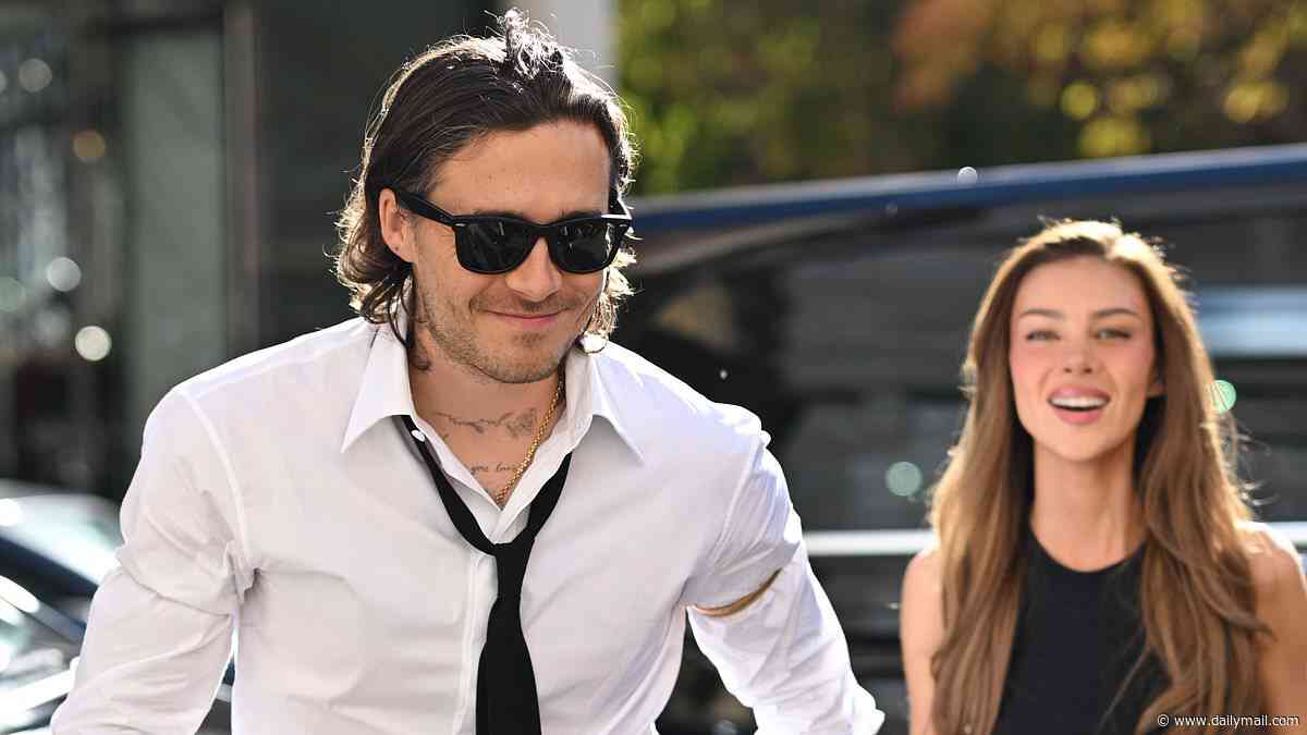 Brooklyn Beckham and Nicola Peltz look blissfully happy together as they hold hands in co-ordinating ensembles at the Balenciaga show
