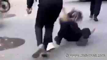 Policewoman is chased down the street, kicked to the ground and beaten by mob as riots rock France