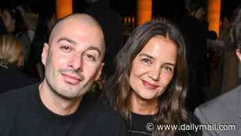 Katie Holmes and boytoy Jason Bard Yarmosky hold hands at Isabel Marant show for Paris Fashion Week