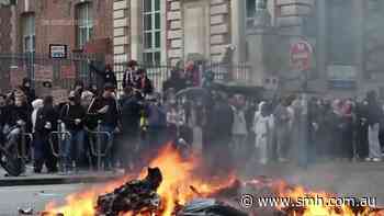 Students in France set trash bins ablaze during protest over school funding